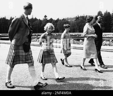 The British royal family stroll at Balmoral castle, Scotland, with Dr. Kwame Nkrumah, the Prime Minister of Ghana on August 12, 1959. Dr. Nkrumah, right, who was born a West African Tribesman, wears western dress while the Queen's husband, Prince Philip, left, and their children, Prince Charles and Princess Anne, wear kilts. Nkrumah was made a privy counselor by Queen Elizabeth II during his visit and discussed possibility of a royal tour later. (AP Photo)