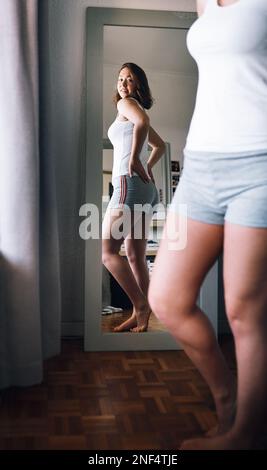 Sexy girl in white panties standing next to mirror, body detail Stock Photo  - Alamy