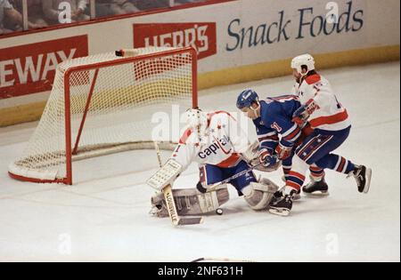 https://l450v.alamy.com/450v/2nf631h/washington-capitals-goalie-mike-liut-left-makes-the-stop-on-new-york-rangers-center-kelly-kisios-shot-on-goal-between-the-defence-of-capitals-defenseman-neil-sheehy-during-the-second-period-of-play-in-game-3-of-the-patrick-division-finals-at-the-capital-center-monday-april-23-1990-in-landover-ap-photoron-edmonds-2nf631h.jpg