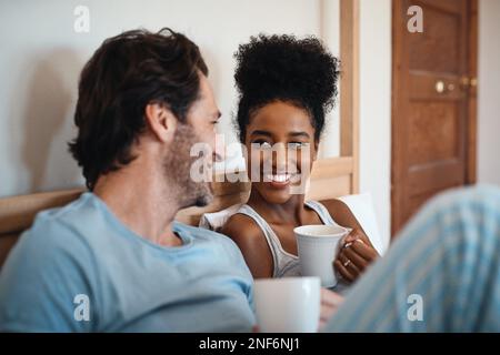 No one knows me like you do. a couple having coffee while lying in bed. Stock Photo