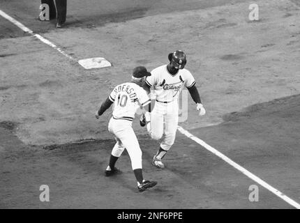 Reggie Smith of the St. Louis Cardinals is congratulated by coach George  Sparky Anderson and the Cincinnati Reds as he heads home after hitting a  home run during the 7th inning of