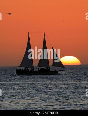 Key West sunset, Gulf of Mexico with the sun and yacht on the background Stock Photo