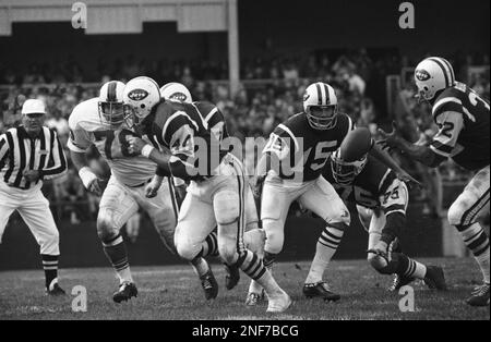 New York Jets John Riggins goes through the motions of a fake handoff  during training session at Rikers Island in New York City, Sept. 26, 1973.  He arrived for training sporting a