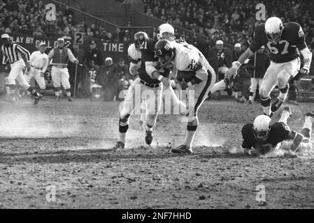 With a ball tucked under his arm, New York Giants Ernie Koy is brought down  from behind by St. Louis Cardinals Jerry Stovall in the first period at  Yankee Stadium, Dec. 18,