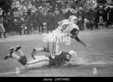 New York Jets John Riggins goes through the motions of a fake handoff  during training session at Rikers Island in New York City, Sept. 26, 1973.  He arrived for training sporting a