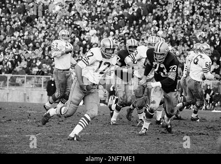 John Brodie (12), San Francisco 49ers quarterback, wasn't quite fast enough  to get away from Dallas Cowboy tackle Bob Lilly (74), who came charging  through the line to drop Brodie for a