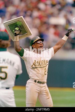 Oakland As Rickey Henderson holds third base over his head after breaking  Ty Cobbs career stole base record against the Toronto Blue Jays at the  Oakland Coliseum, Tuesday, May 29, 1990, Oakland