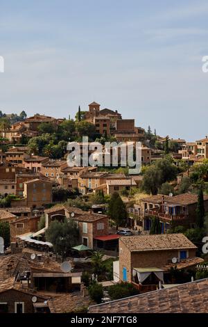 An aerial view of cityscape Deia surrounded by buildings Stock Photo