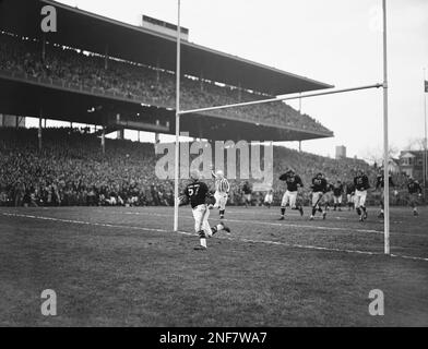 Sid Luckman, left, Chicago Bears' quarterback, gets a hug and a kiss from  teammate George McAfee, center, as Ray McLean, right, watches in the  dressing room following Chicago's defeat of the New