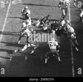 Gale Sayers of the Chicago Bears, moves ball toward Pittsburgh goal line as  he is tackled short of pay dirt in first period in Chicago on November 9, 1969. Tackling Sayers are Andy