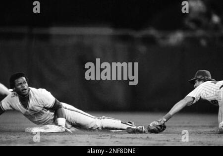 Oakland As Rickey Henderson holds third base over his head after