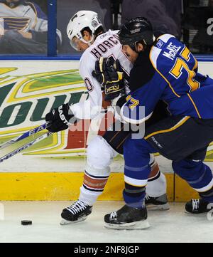 St. Louis Blues Jay McKee (L) pushes Chicago Blackhawks Jassen Cullimore  off of the puck in the first period at the Scottrade Center in St. Louis on  January 4, 2007. (UPI Photo/Bill