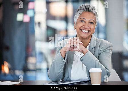 Smile, executive and portrait of a woman in business for working, success and goals. Corporate, happy and mature office employee sitting at a desk to Stock Photo