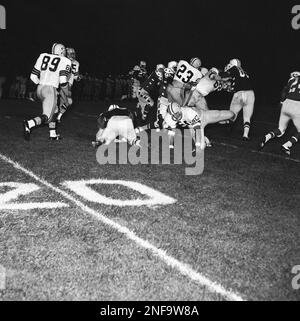 Green Bay Packers Travis Williams (23) runs over his blocker, Donny Anderson  (44), during game against Philadelphia Eagles at Milwaukee, Oct. 26, 1970.  Williams kept his balance and made about six yards. Anderson was blocking  Eagles' Adrian Young