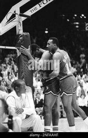 Dallas Mavericks Mark Aguirre (24) picks his way though Golden State  Warriors Mickey Johnson's feet after Aguirre came up with a rebound in  first half play at Reunion Arena in Dallas Saturday