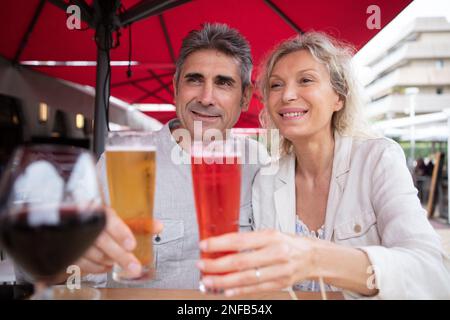 happy seniors talking and smiling during dinner Stock Photo