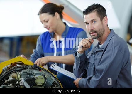 an apprentice is studying engines Stock Photo