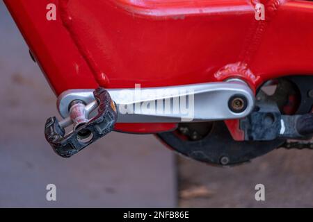 Detail of the pedal of red shared rental bicycles parked in a row on a street in the city of Barcelona. Stock Photo