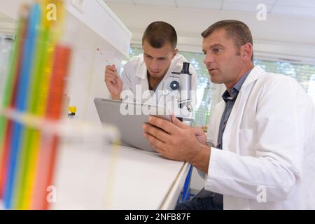 two male scientists looking at tablet pc Stock Photo