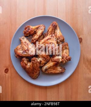 Chicken Popcorn, Wings and Tenders with BBQ Sauce on a plate on a gray background, top view. Flat lay, overhead, from above Stock Photo
