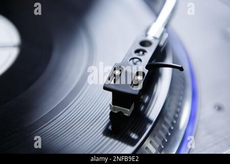 Turntables needle on vinyl record. Tone arm with professional spherical needle on turn table player Stock Photo