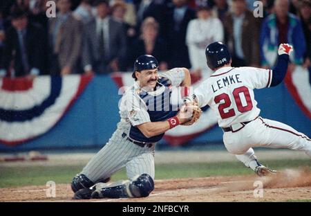 Atlanta Braves Mark Lemke (20) slides past Minnesota Twins catcher Brian  Harper (12) to score the game-winning run in the 9th inning of Game 4 of  the World Series at Atlanta, Ga., Oct. 23, 1991. Lemke, who triple-scored  on a pinch hit sacrifice fly by 