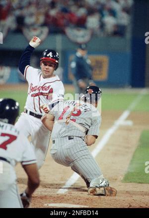 Atlanata Braves Mark Lemke slides home safely past Minnesota Twins catcher  Brian Harper to score the game-winning run in the 9th inning of Wednesday's  World Series game. In the early hours of