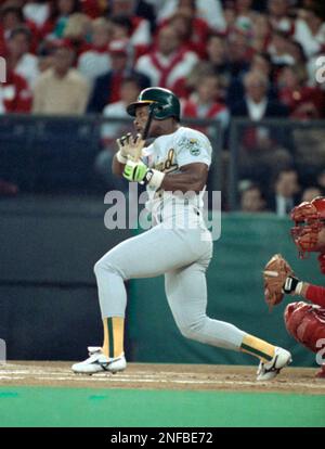Oakland Athletics Rickey Henderson leads off game two of the World Series  with a broken bat single over the Cincinnati Reds, Oct. 17, 1990, Cincinnati,  Ohio. Henderson later stole second and then scored the Athletics first run  of the game on a sacrific