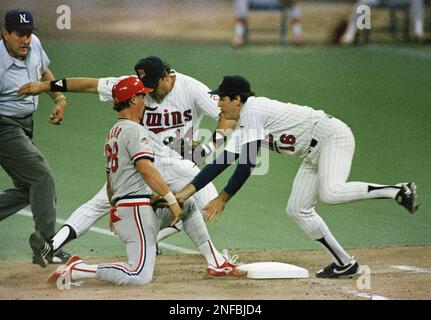 Minnesota Twins pitcher Frank Viola (16) speaks with Twins Gary Gaetti (8)  as the St. Louis Cardinals celebrate at home plate in the fourth inning of  game 4 of the World Series