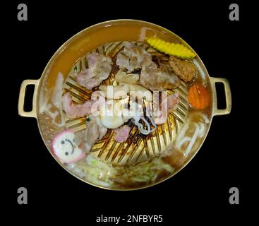 Top view of grilled roasted pork slice on korean barbecue brass pan, focus selective Stock Photo