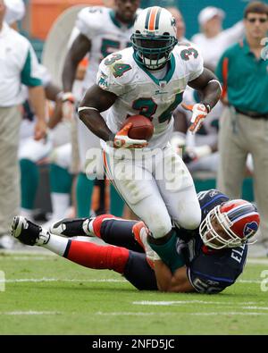 Miami Dolphins' Ricky Williams (34) scores on a 1-yard run in the fourth  quarter against the Buffalo Bills Sunday, Sept. 21, 2003, in Miami. Williams  carried a franchise-record 42 times for 153