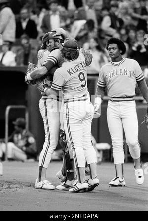 Oakland A's and New York Yankees players hold back Yankees Dave Winfield (31),  and A's pitcher Steve McCatty, right, after Winfield charged McCatty with a  brush back pitch in the second inning