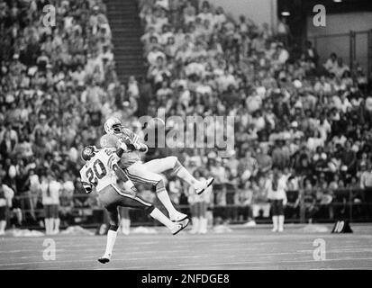 Houston Oilers wide receiver Ken Burrough (00) does a spread flip over  Cincinnati Bengals' Ken Riley (13) in the first quarter of the NFL game at  Houston on Sunday, Dec. 18, 1977.