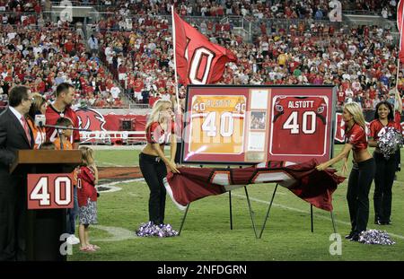 Tampa Bay Buccaneers great Mike Alstott's first game jersey, left, along  side of his last game jersey, are displayed during a special tribute during  the half time of an NFL football game