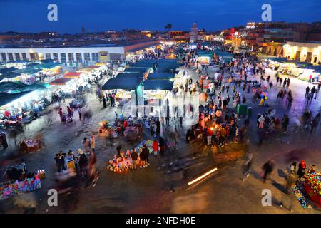 MARRAKESH, MOROCCO - FEBRUARY 20, 2022: People visit Jemaa el-Fnaa square market of Marrakesh city, Morocco. The square is listed as UNESCO Masterpiec Stock Photo