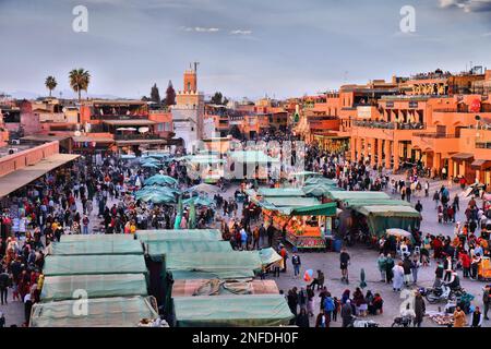 MARRAKESH, MOROCCO - FEBRUARY 20, 2022: People visit Jemaa el-Fnaa square market of Marrakesh city, Morocco. The square is listed as UNESCO Masterpiec Stock Photo