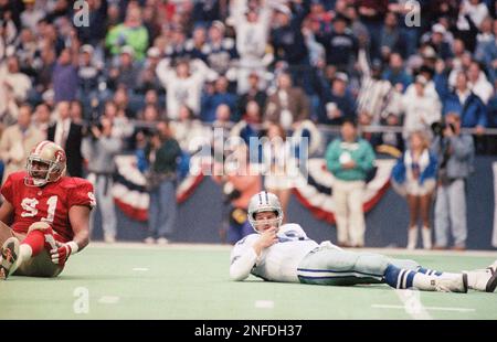 Dallas Cowboys quarterback Bernie Kosar (18) prepares to pass, as offensive  tackle Erik Williams (7) holds of San Francisco 49ers' defensive end Larry  Roberts (91) in the third quarter of the NFC