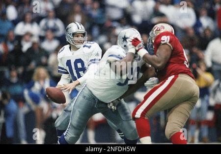 Dallas Cowboys quarterback Bernie Kosar scrambles under the pressure of  Phoenix Cardinals defensive lineman Reuben Davis (93) in the third quarter,  Nov. 14, 1993 in Irving, Texas. (AP Photo/Eric Gay Stock Photo - Alamy