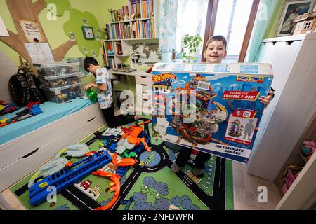 Ternopil, Ukraine - February, 2023: Boy Unboxing Hot Wheels City