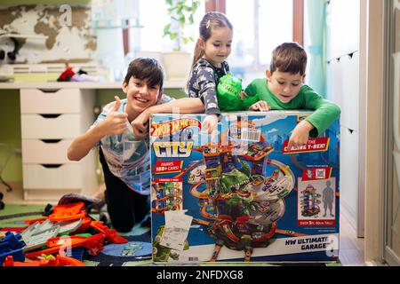 Ternopil, Ukraine - February, 2023: Kids unboxing Hot Wheels City