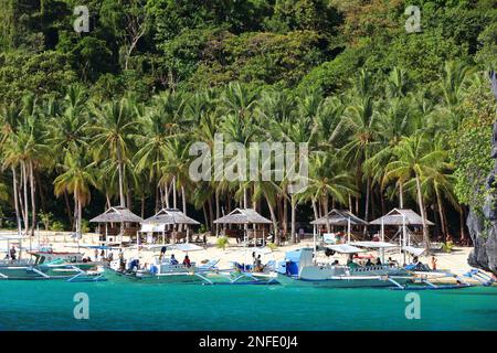 PALAWAN, PHILIPPINES - DECEMBER 1, 2017: People visit Seven Commando Beach on an island hopping tour in Palawan, Philippines. 6 million foreign touris Stock Photo