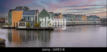 Panorama of famous colorful wooden houses by the Rietplas lake in Houten, Province Utrecht, The Netherlands, at sunrise Stock Photo