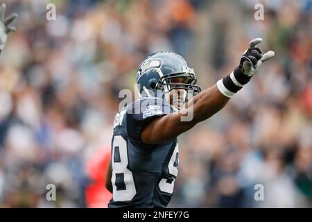 Seattle Seahawks' linebacker Julian Peterson (C) talks with defensive  tackles Ellis Wyms (L) and Craig Terrill (R) during a timeout in the fourth  quarter at Qwest Field in Seattle on November 12