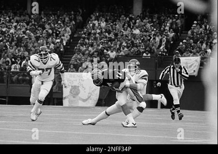 Cincinnati Bengals quarterback Ken Anderson has his head turned almost  completely around by Piuttsburgh Steeler defender Keith Gary (92) during  the second quarter of their NFL game at Riverfront Dtadium in Cincinnati