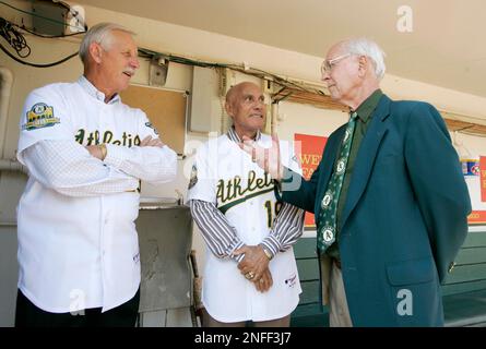 From left, Oakland Athletics 40th anniversary team members Rickey  Henderson, Joe Rudi and Dave Stewart laugh during a ceremony before the A's  baseball game against Seattle in Oakland, Calif., Sunday, Sept. 21