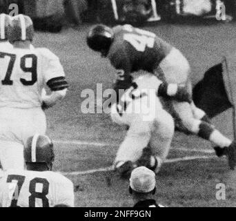 New York Giants quarterback Charley Conerly (42) hands off the ball to Alex  Webster (29) as part of a double hand-off and lateral play resulting in the  only touchdown of the NFC