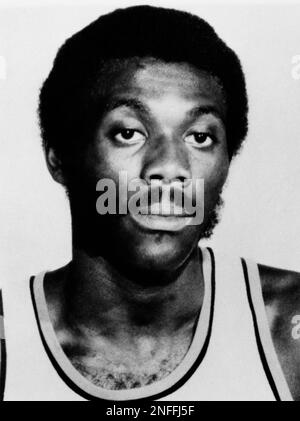 While 76ers Harvey Catchings keep Buffalo Braves Bob McAdoo (11) from  turning toward the basket 76ers teammate Steve Mix tries to knock the ball  free during the first quarter of NBA game