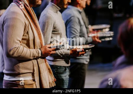 Communion with bread and wine during the service in the assembly Stock Photo