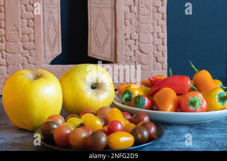 An assortment of colorful vegetables and fruit sitting on a table. Stock Photo