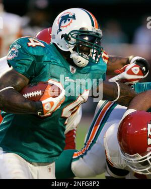 Miami Dolphins running back Ricky Williams (34) is brought down by Buffalo  Bills linebacker Keith Ellison, bottom, in the second quarter during a NFL  football game at Dolphin Stadium in Miami, Sunday